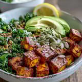 Tofu Breakfast Bowl with Avocado and Kale served hot with avocado, green onions, and a sprinkle of nutritional yeast.
