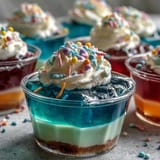 Fun and colorful Rainbow Jello Cups for Kids, featuring red, orange, yellow, green, blue, and purple fruity gelatin layers.  