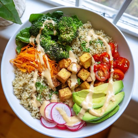 Hearty Buddha Bowl featuring brown rice, chicken, spinach, and carrots, topped with toasted sesame seeds and fresh herbs.