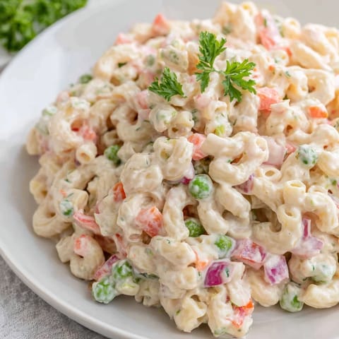 A colorful bowl of homemade Macaroni Salad ready for a summer picnic.