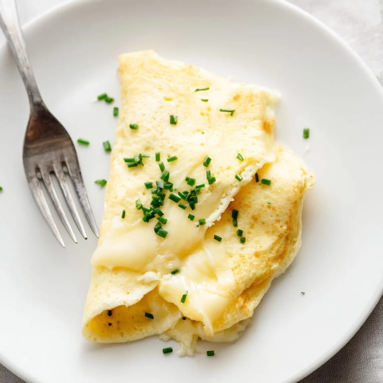 Overhead view of a cheesy omelet with optional bell peppers and ham filling.