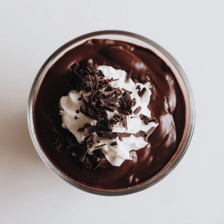 Decadent Chocolate Pudding dessert in a small bowl, dusted with cocoa powder and ready to be served.