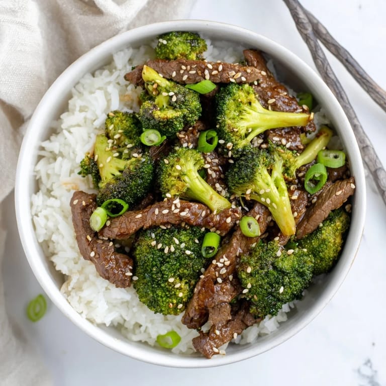 Tender beef and crisp broccoli come together in a classic Beef and Broccoli recipe, finished with a drizzle of sesame oil.