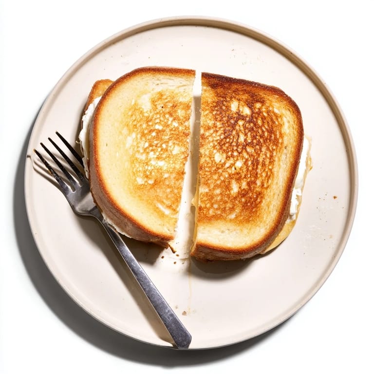 Thick slices of Whipped Feta Spring Grilled Cheese served on a ceramic plate, ready to eat.