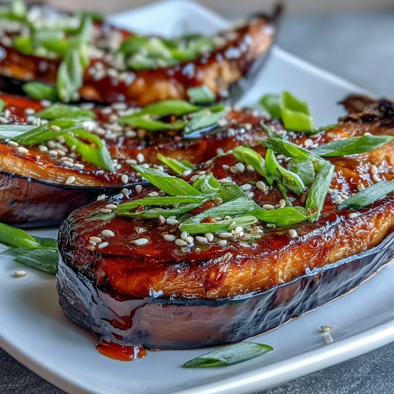 Silky Japanese eggplant brushed with sweet-savory miso glaze, broiled to perfection and served warm over steamed rice.