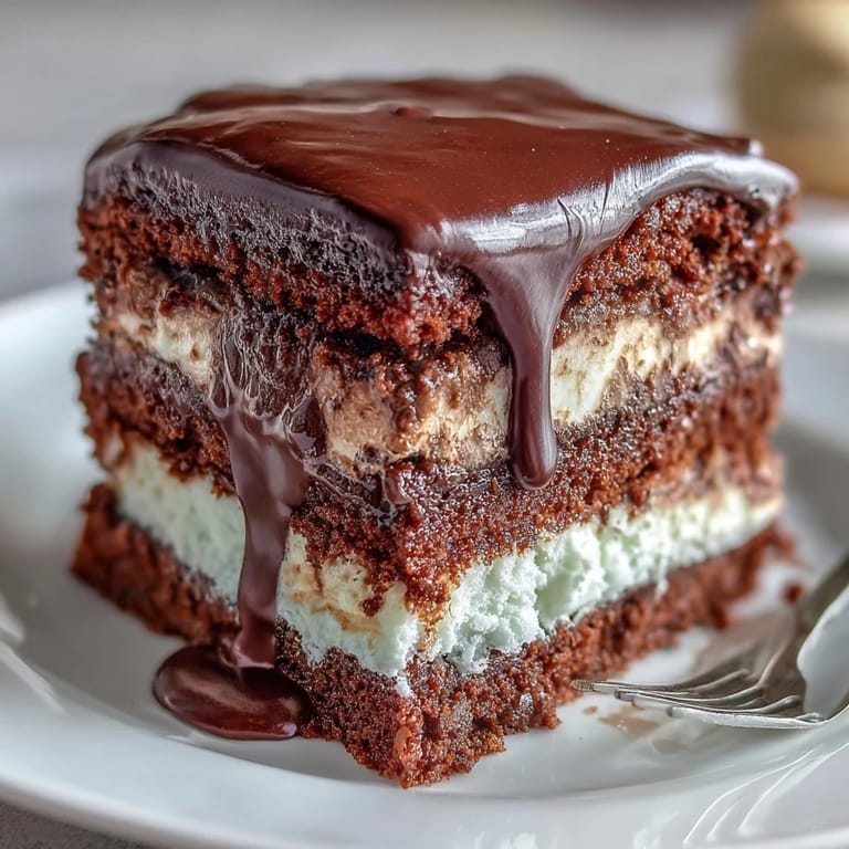 Elegant vanilla sponge cake covered in silky white chocolate buttercream, topped with a dramatic white chocolate drip and festive gold balloons.