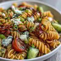 Lemon Vinaigrette Pasta Salad with Cucumbers and Cherry Tomatoes: A bright, refreshing pasta salad tossed with crisp cucumbers, juicy cherry tomatoes, and a tangy lemon vinaigrette, perfect for summer gatherings.